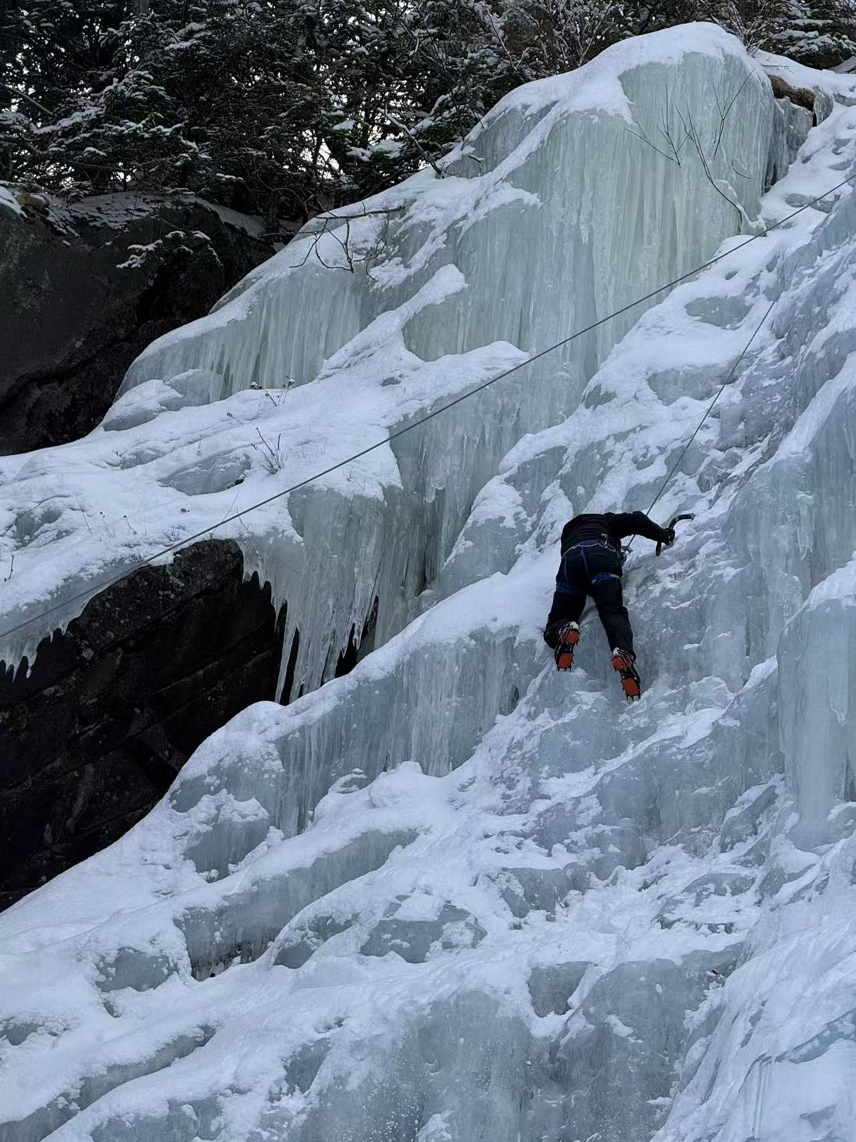 Ice climbing on a frozen waterfall